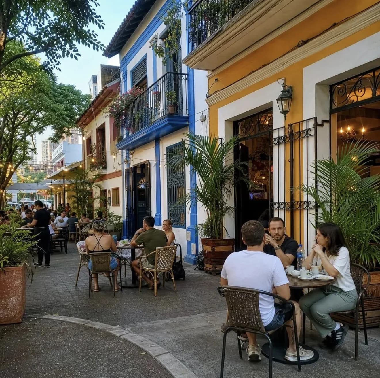 Outdoor cafe in Cali, Colombia with people dining along a colorful street