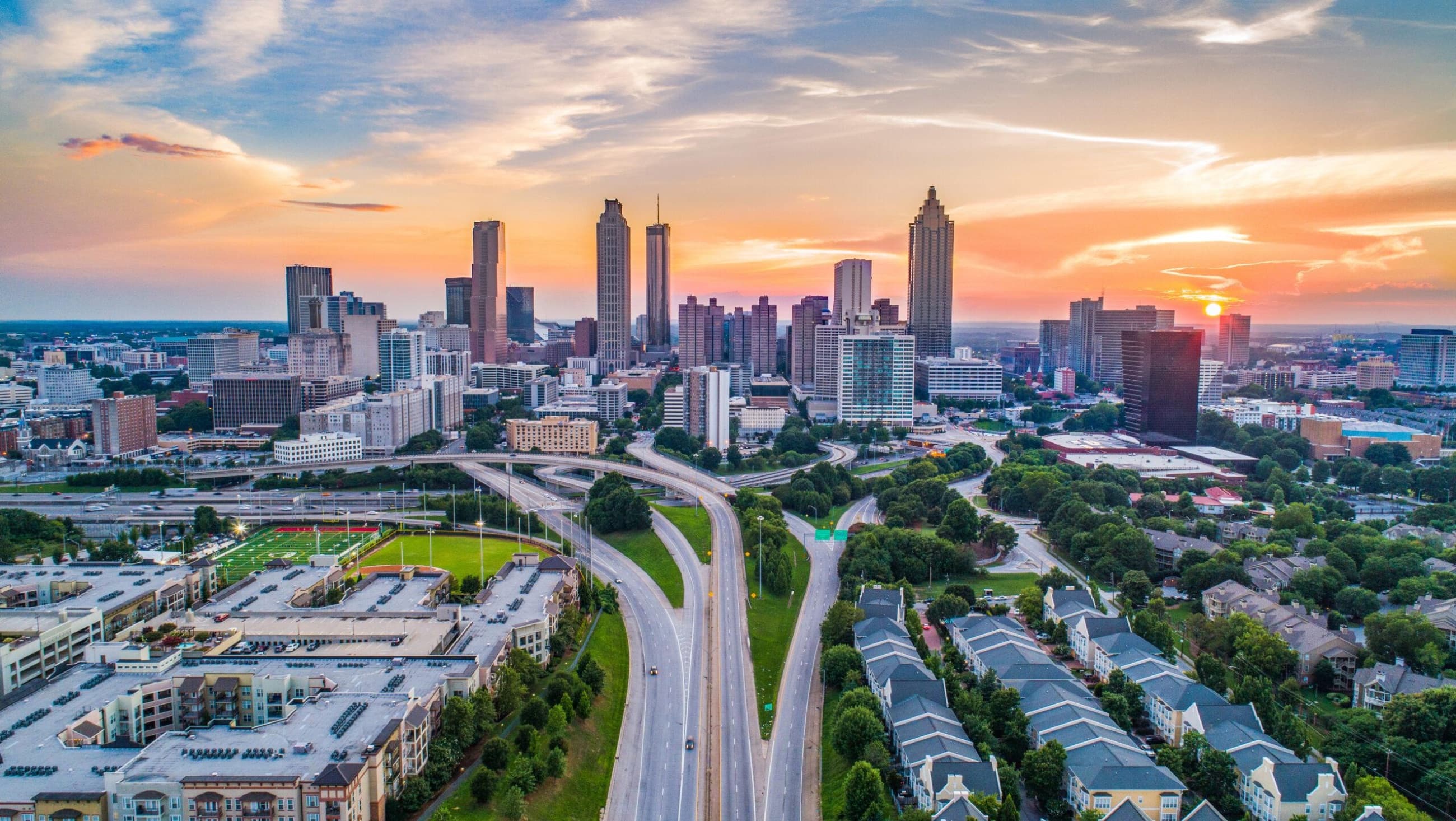 An urban skyline and transportation network at sunset