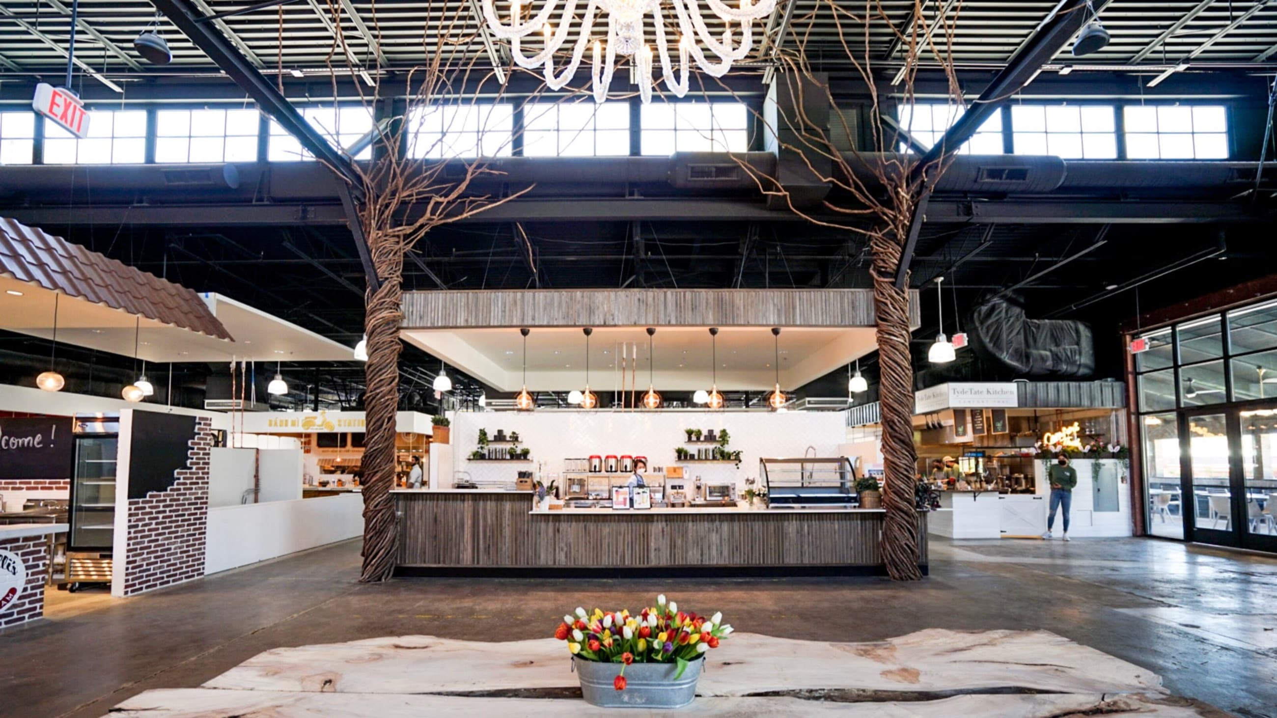 An active food hall where people work, meet, dine, and shop